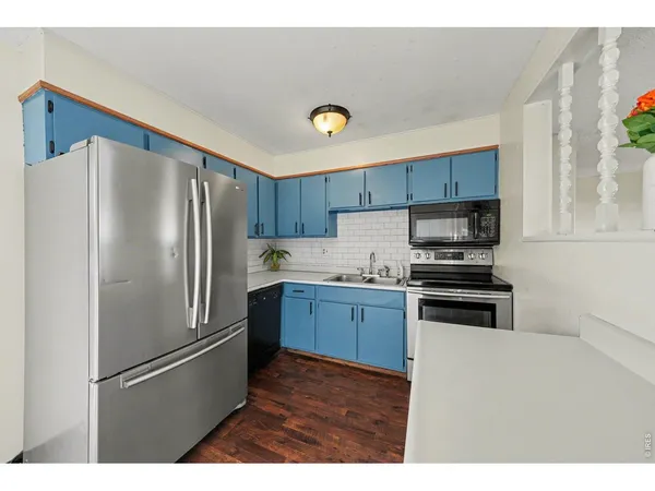 a kitchen with stainless steel appliances a refrigerator and a stove