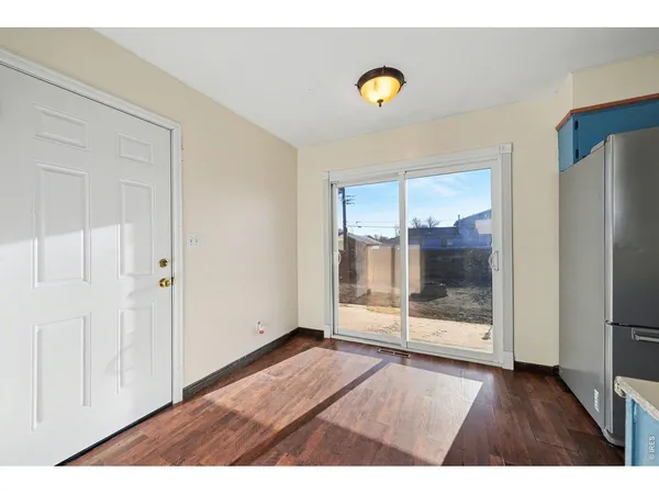 a view of wooden floor and windows in a room