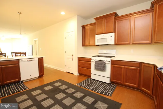 a kitchen with stainless steel appliances a stove a sink and cabinets