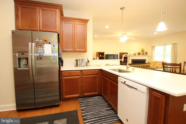 a kitchen with stainless steel appliances granite countertop a refrigerator and a sink