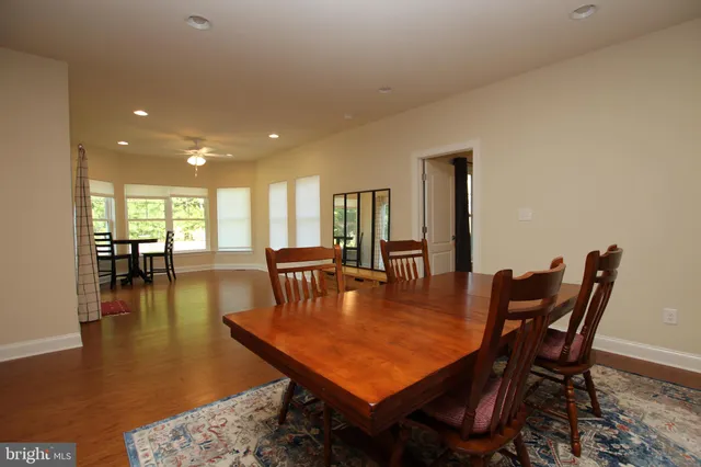 a dining room with furniture and wooden floor
