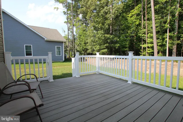 a view of a chair and table on the wooden deck