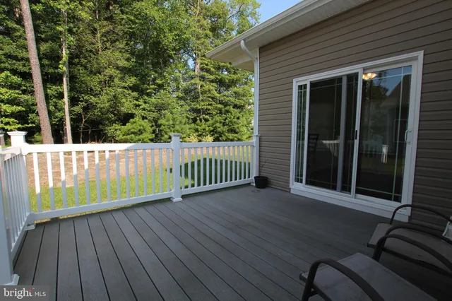 a view of a wooden deck with a yard