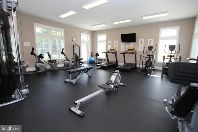a room with gym equipment and a large window
