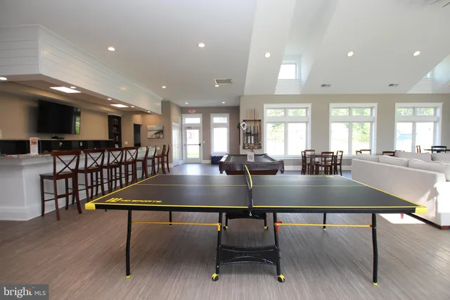 a view of a kitchen with kitchen island a table and chairs