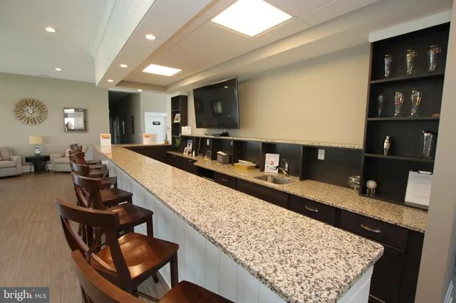 a large living room with a couch and a flat screen tv