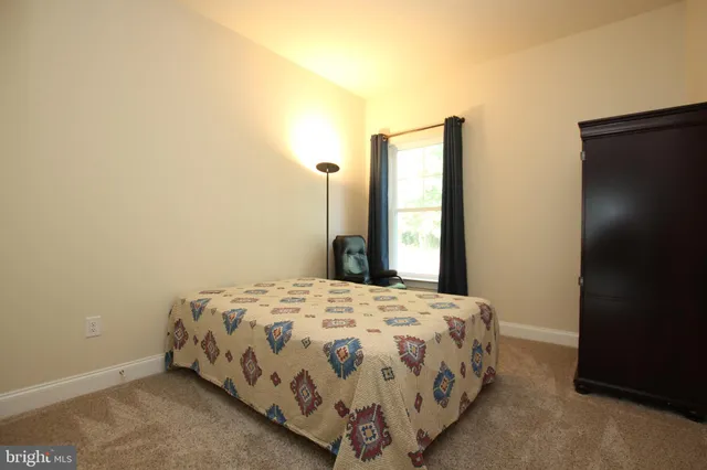 a bedroom with a bed and a night stand