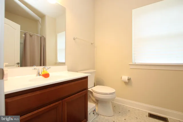 a bathroom with a sink toilet and vanity