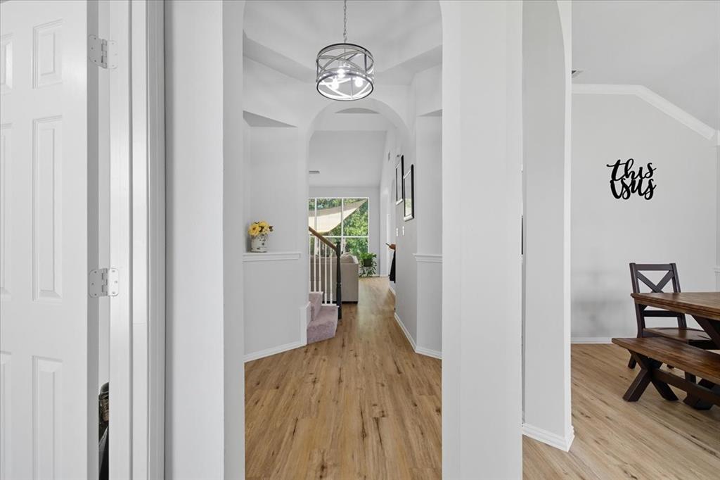 409 Springtree Road Lake Dallas, TX 75065 - Photo 5 of 40 Wood-finish flooring throughout, framed by light gray walls