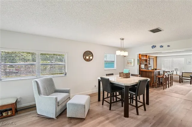 a view of a dining room with furniture and window