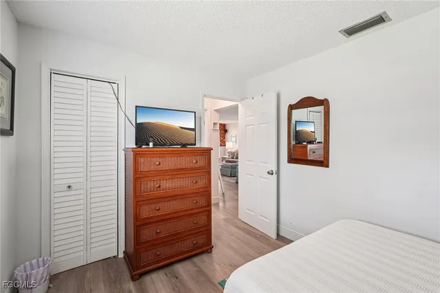 a bedroom with a bed and a dresser