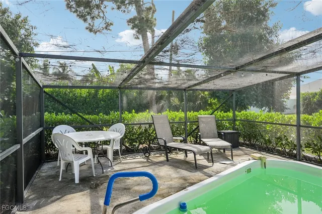 a view of a patio with a table chairs and a backyard