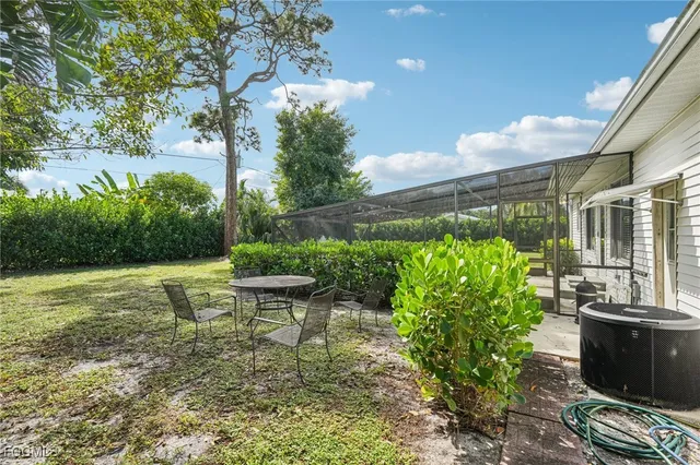 a garden with chairs in front of the house