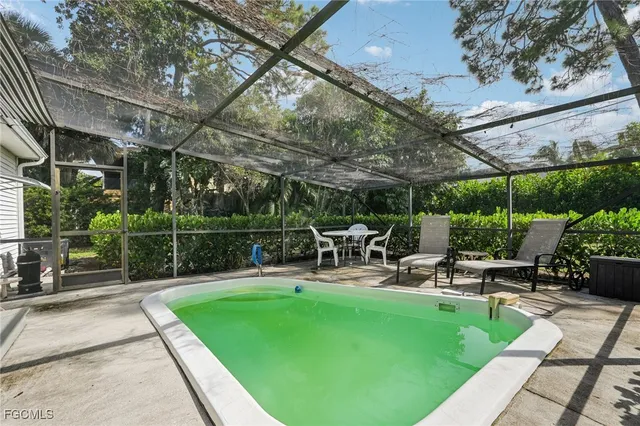 a view of a backyard with sitting area and slide
