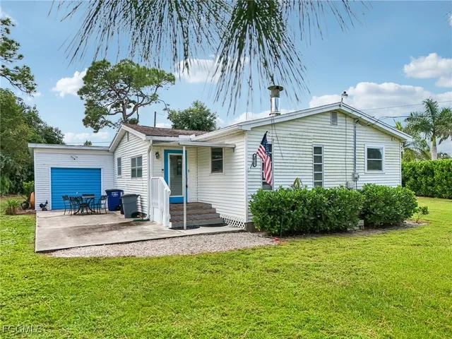 a front view of house with yard and outdoor seating