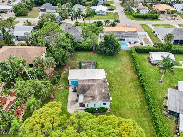 an aerial view of a house with a garden and lake view