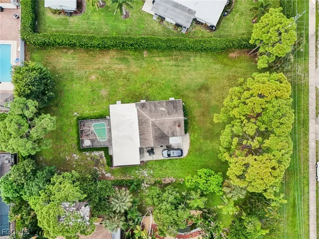 an aerial view of a house with a yard and lake view