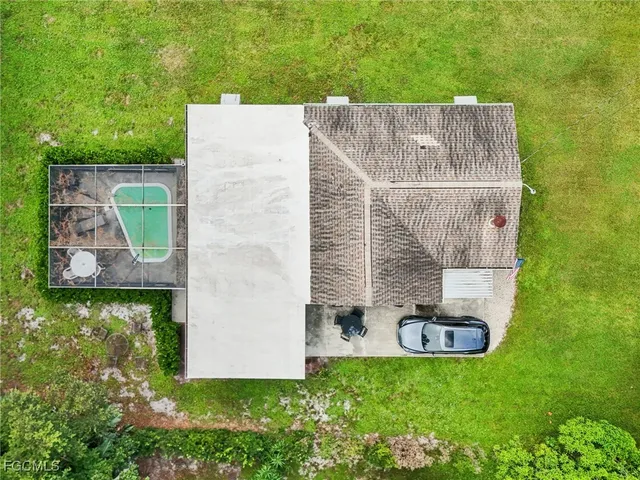 an aerial view of a house with a yard