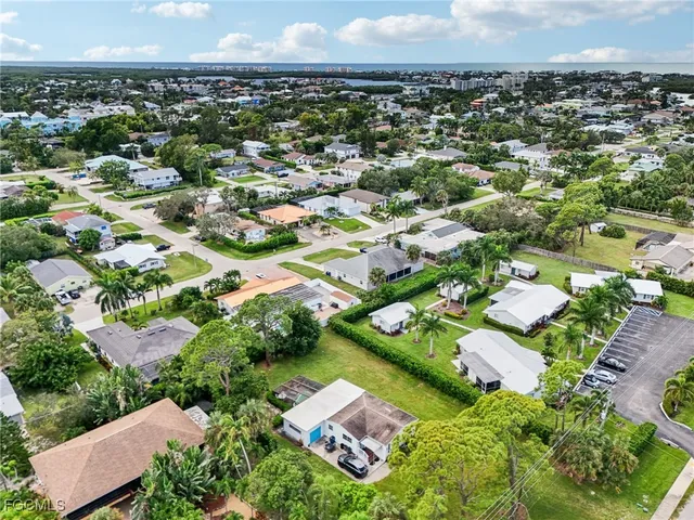 an aerial view of residential houses with outdoor space and street view