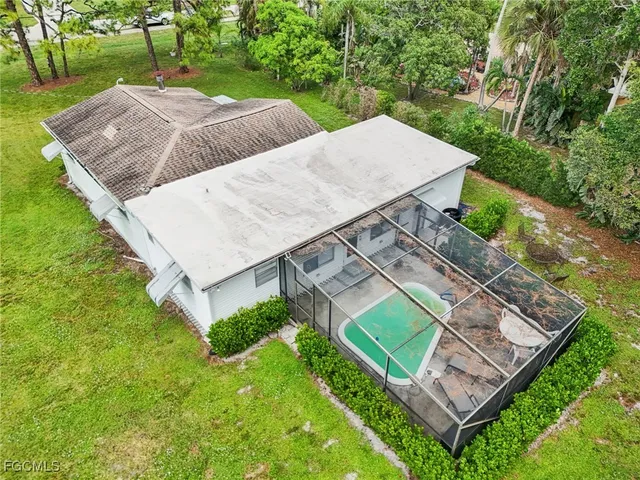 an aerial view of a house with a yard