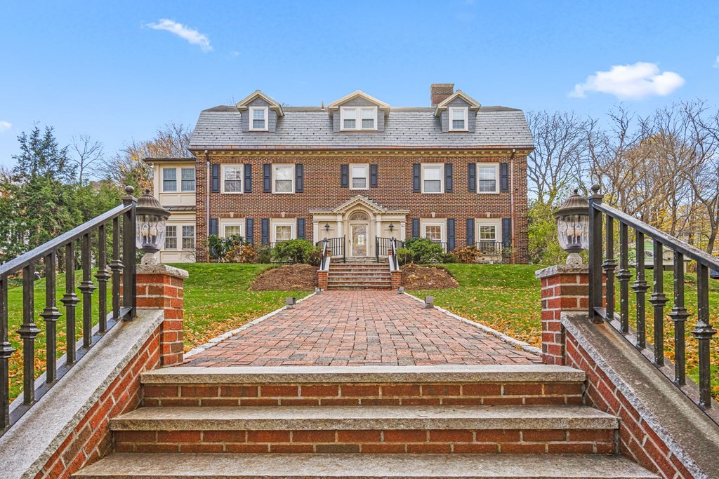 a view of a brick house with a yard