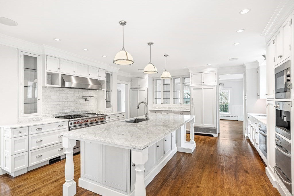106 Clinton Road Brookline, MA 02445 - Photo 13 of 42 a kitchen with stainless steel appliances granite countertop a stove and cabinets with wooden floor