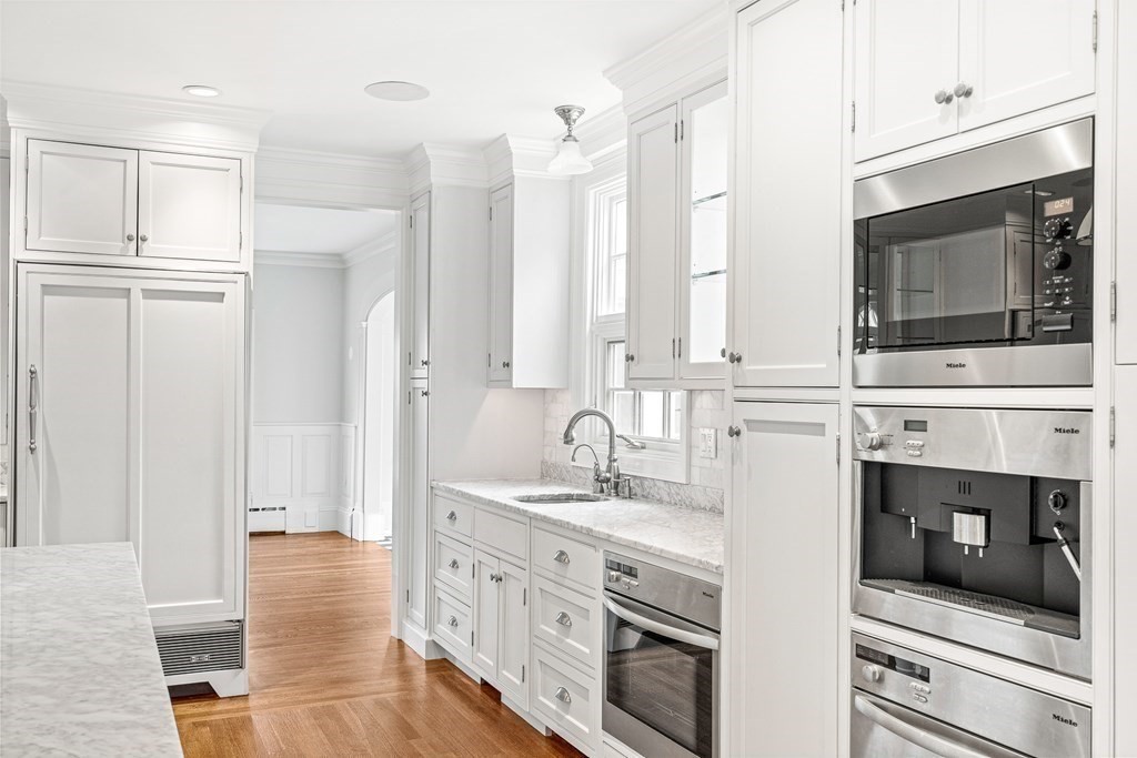 106 Clinton Road Brookline, MA 02445 - Photo 14 of 42 a kitchen with stainless steel appliances a stove microwave and cabinets