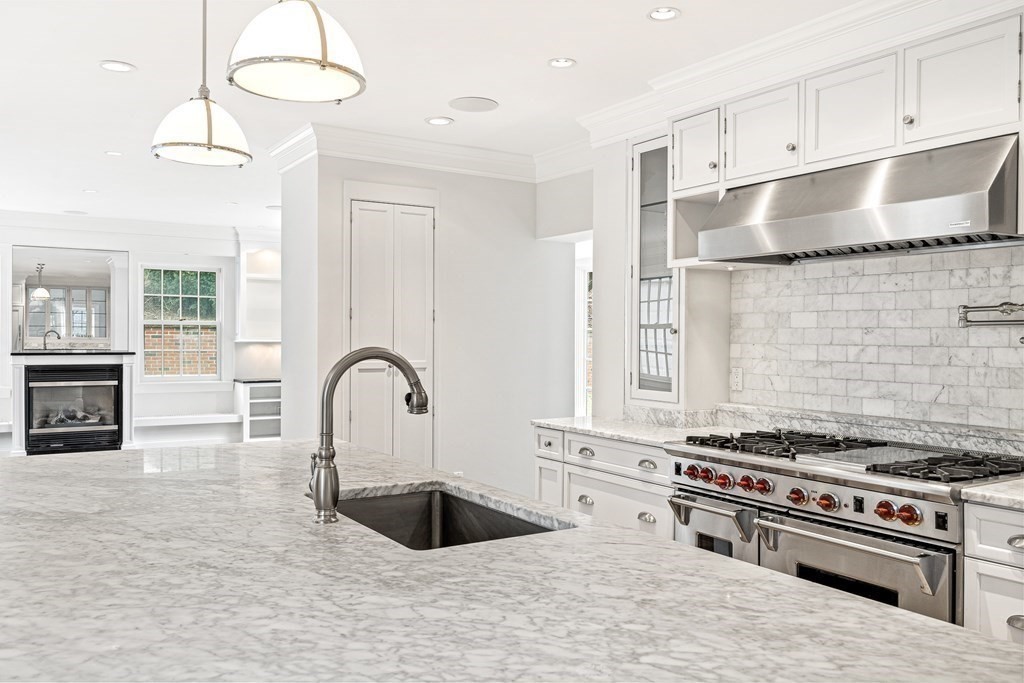 106 Clinton Road Brookline, MA 02445 - Photo 15 of 42 a kitchen with stainless steel appliances granite countertop a stove a sink and a refrigerator