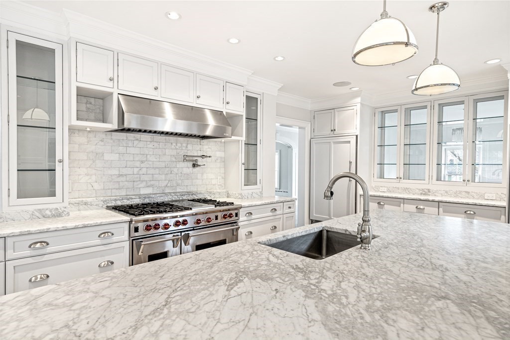 106 Clinton Road Brookline, MA 02445 - Photo 16 of 42 a kitchen with granite countertop a stove a sink and a refrigerator
