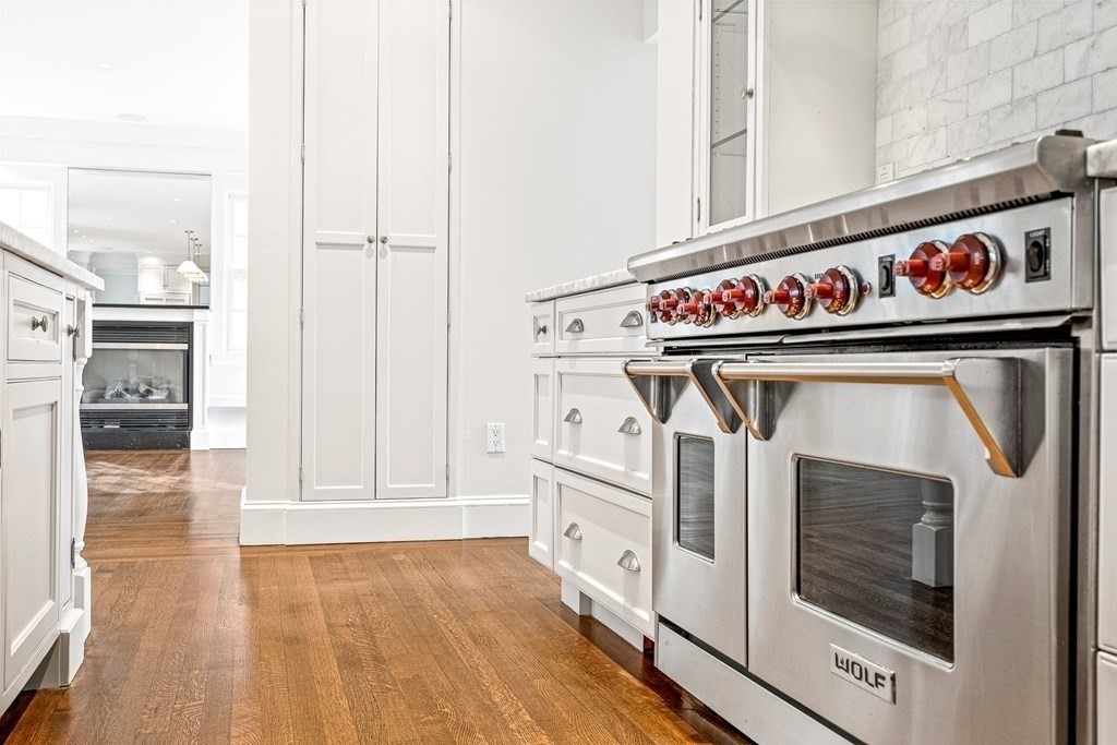 106 Clinton Road Brookline, MA 02445 - Photo 17 of 42 a utility room with stainless steel appliances granite countertop a stove and a refrigerator