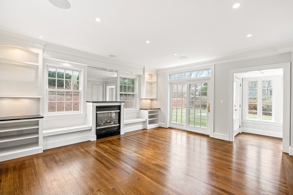 106 Clinton Road Brookline, MA 02445 - Photo 18 of 42 wooden floor fireplace and windows in an empty room