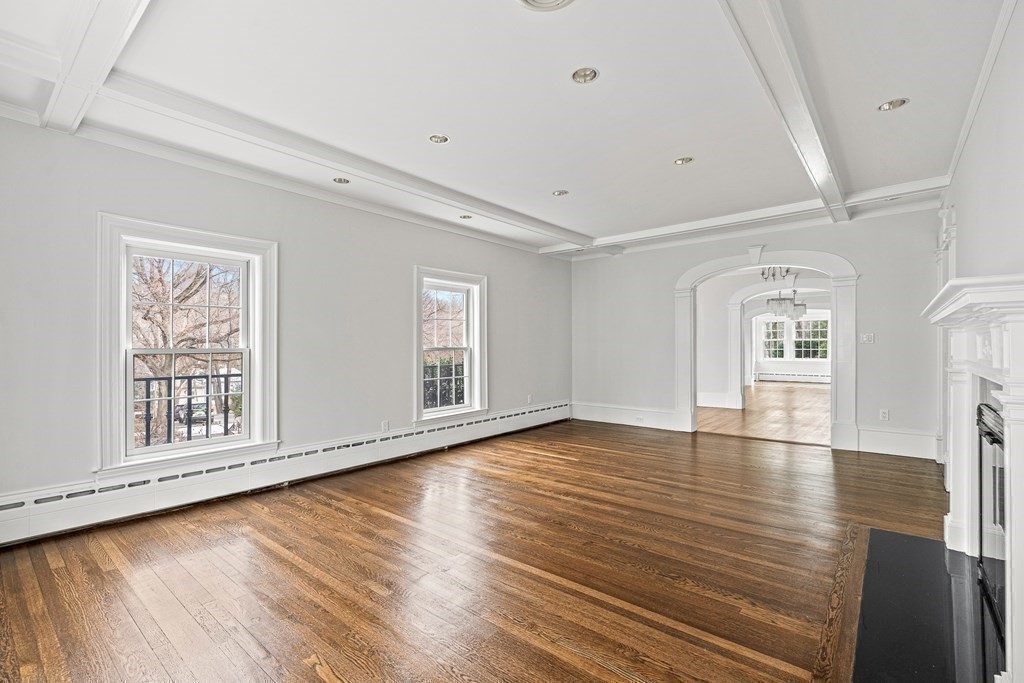 106 Clinton Road Brookline, MA 02445 - Photo 22 of 42 a view of an empty room with wooden floor and window