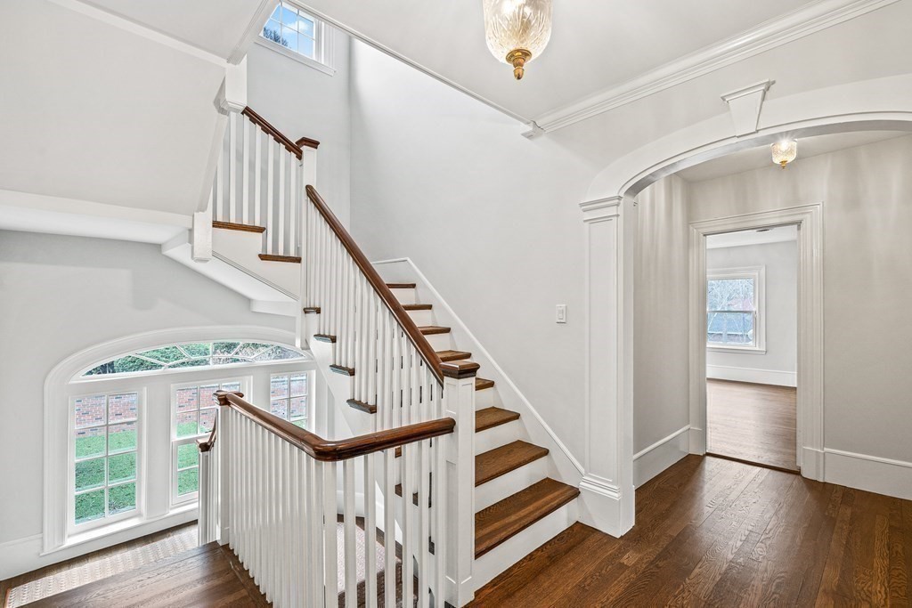 106 Clinton Road Brookline, MA 02445 - Photo 23 of 42 a view of entryway with wooden floor and stairs