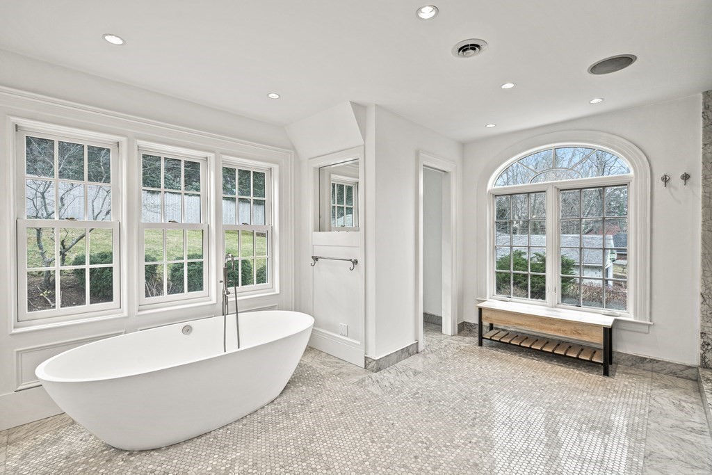 106 Clinton Road Brookline, MA 02445 - Photo 28 of 42 a bathroom with a tub and glass door