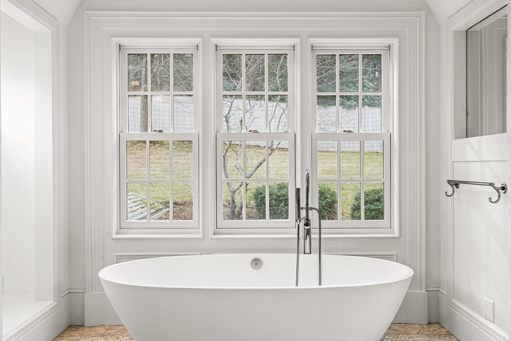 106 Clinton Road Brookline, MA 02445 - Photo 29 of 42 a white bath tub sitting next to a window