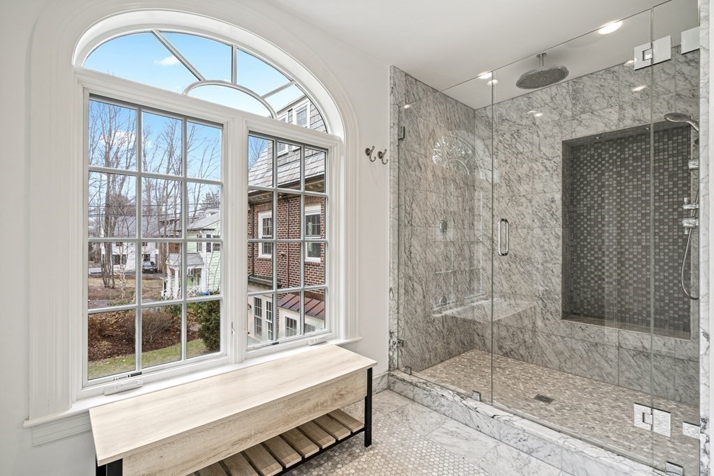 106 Clinton Road Brookline, MA 02445 - Photo 30 of 42 a bathroom with a glass door shower and a sink