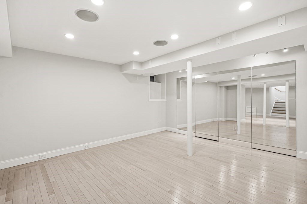 106 Clinton Road Brookline, MA 02445 - Photo 42 of 42 an empty room with wooden floor and windows