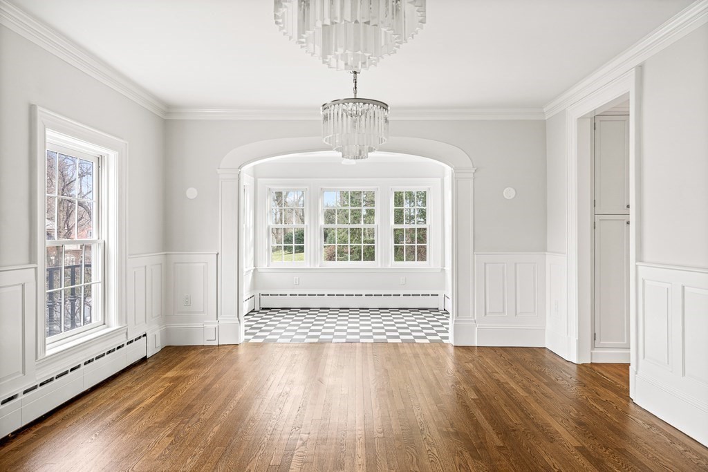 106 Clinton Road Brookline, MA 02445 - Photo 7 of 42 a view of an empty room with wooden floor and a window