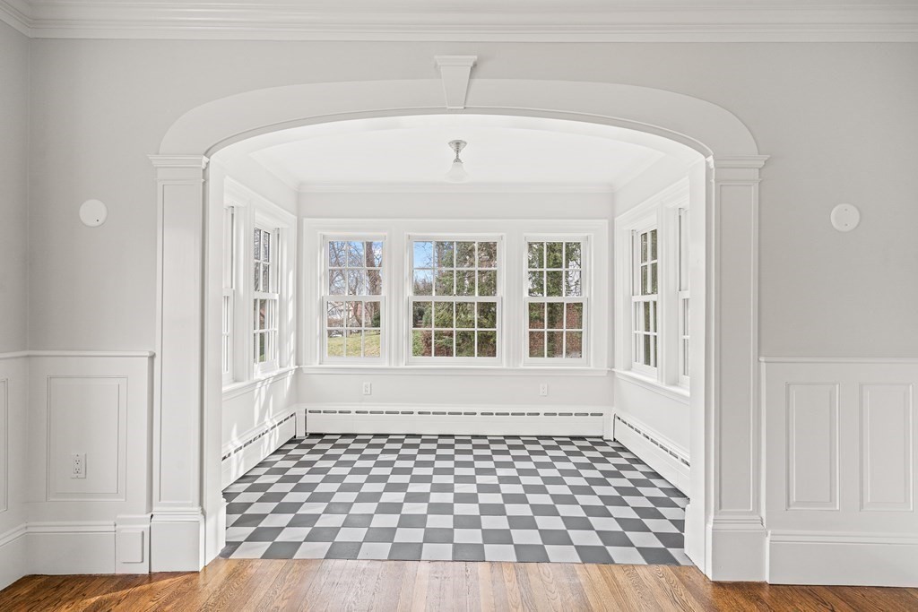 106 Clinton Road Brookline, MA 02445 - Photo 8 of 42 a view of empty room with wooden floor and windows