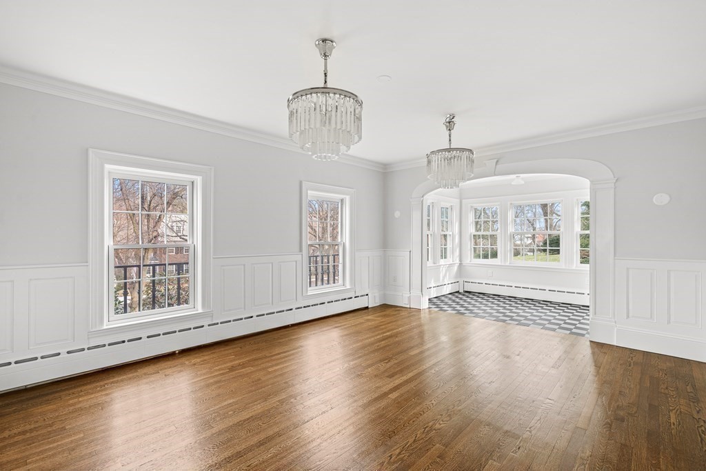 106 Clinton Road Brookline, MA 02445 - Photo 9 of 42 a view of an empty room with wooden floor and a window