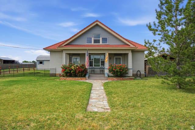 5264 West 5500th Street South Hooper, UT 84315 - Photo 1 of 38 Charming exterior featuring a stone walkway, covered porch, red tile roof, and gabled dormer