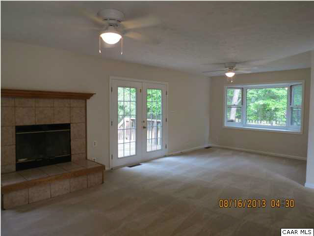 3 Deer Path Road Palmyra, VA 22963 - Photo 2 of 13 an empty room with windows and fireplace
