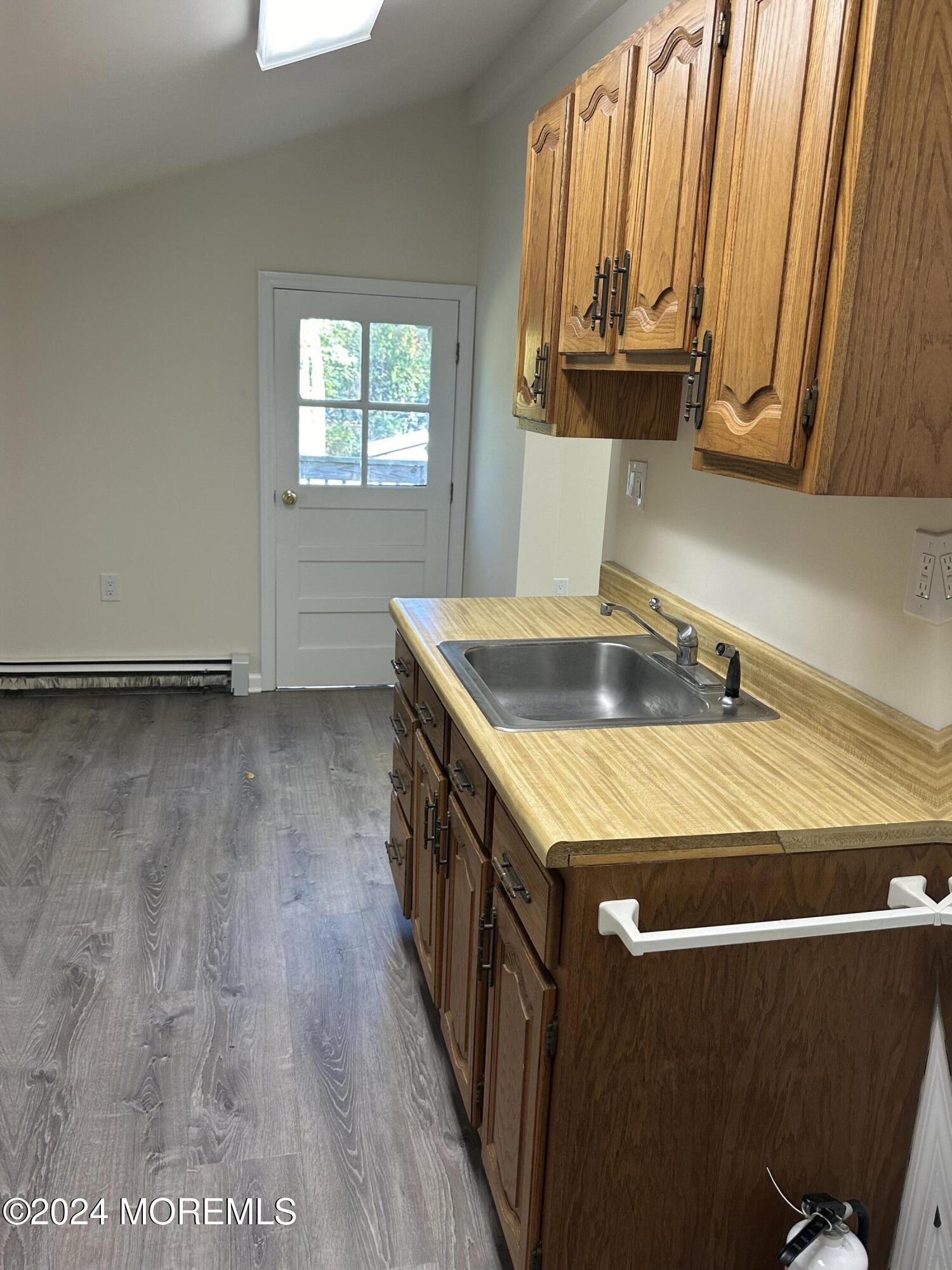 1 Leonardville Road, Unit C Middletown, NJ 07748 - Photo 12 of 12 a kitchen with a wooden floor window and a sink