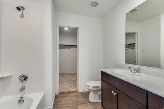 a kitchen with granite countertop a sink wooden cabinets and stainless steel appliances
