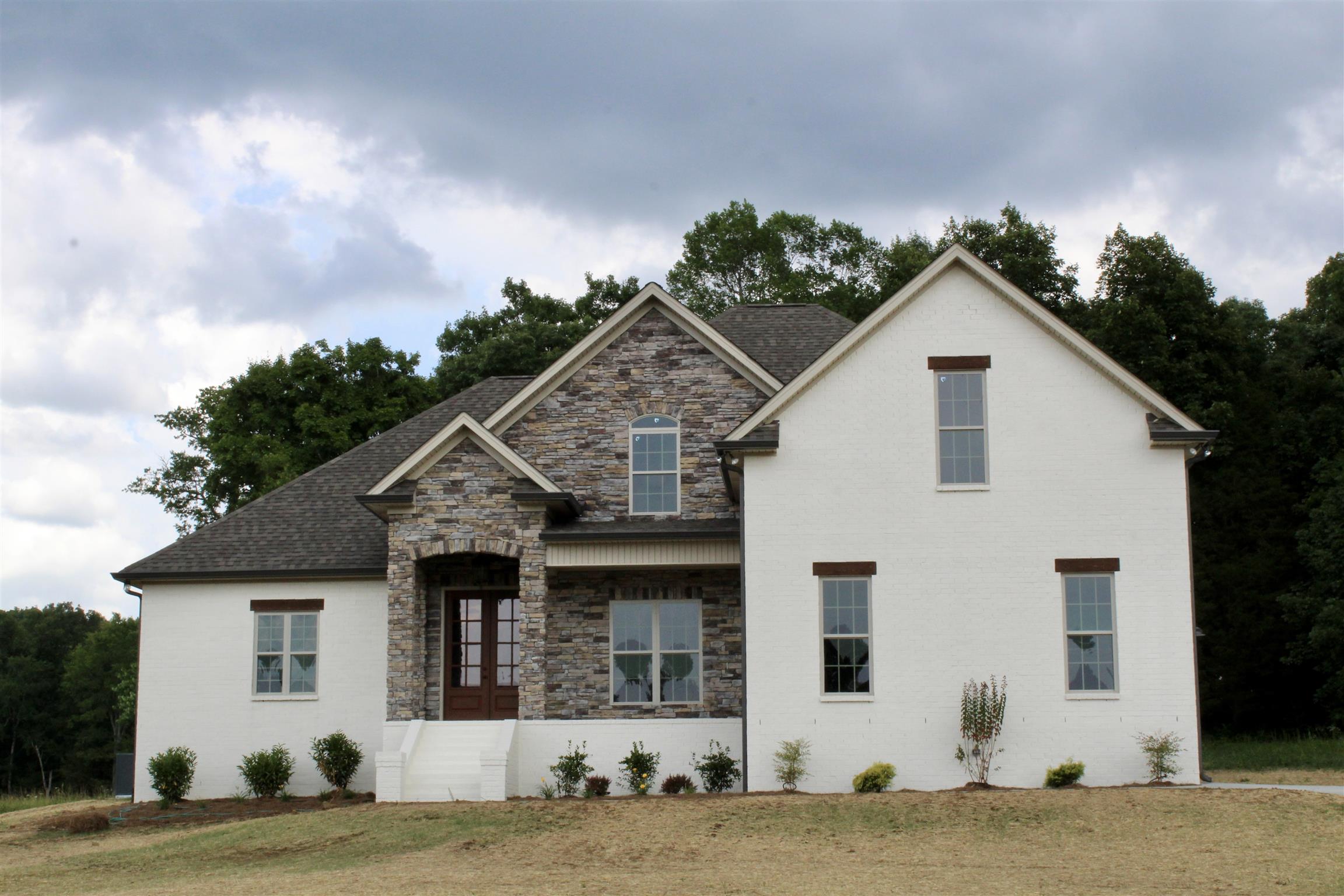1381 Walnut Hill Road Lebanon, TN 37090 - Photo 3 of 26 a front view of a house with a garden