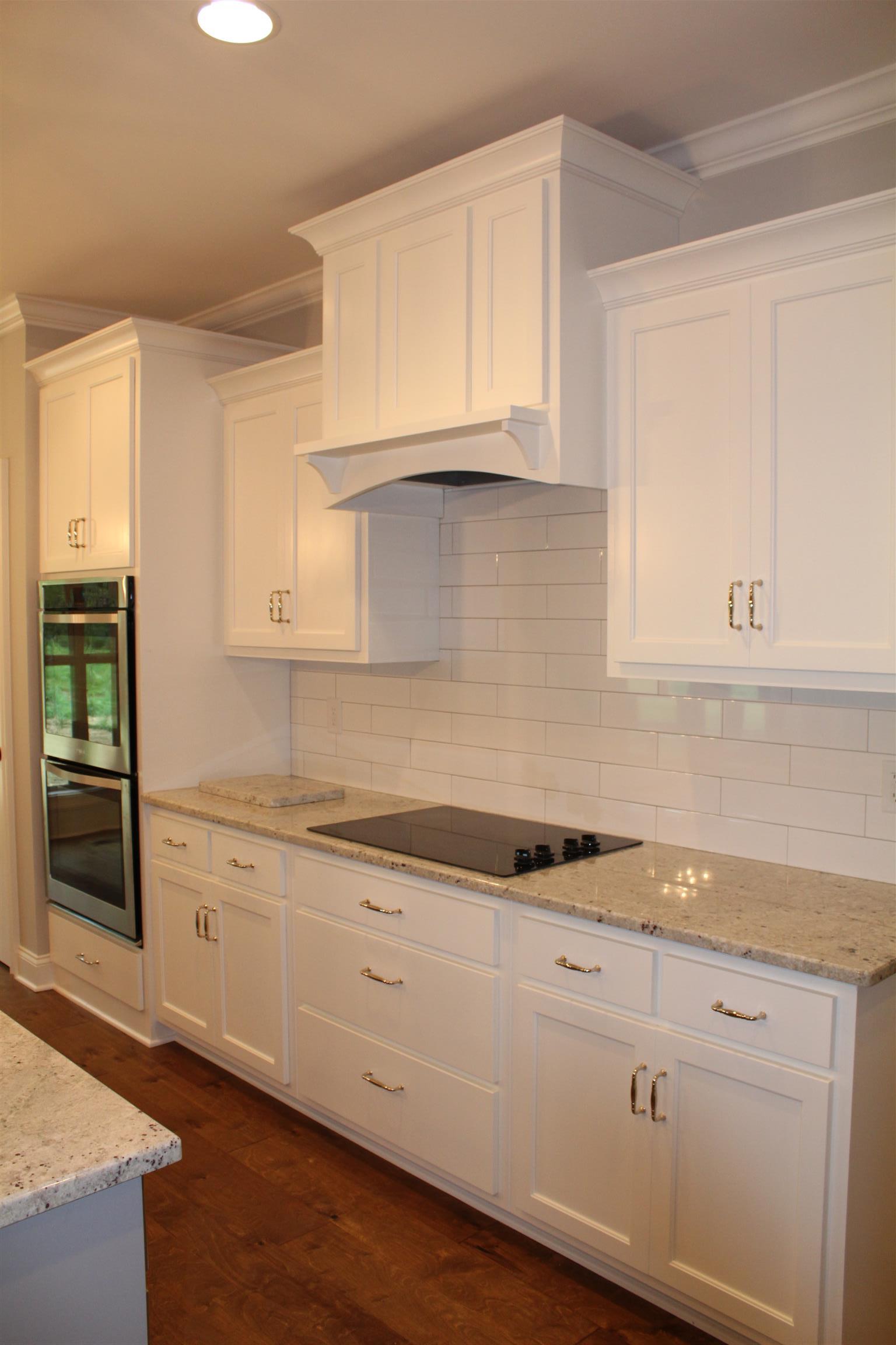 1381 Walnut Hill Road Lebanon, TN 37090 - Photo 9 of 26 a kitchen with granite countertop white cabinets and white appliances