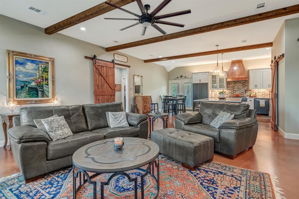 129 Whiskey Rnch Road Runaway Bay, TX 76426 - Photo 10 of 39 a living room with furniture a rug potted plant and a large window