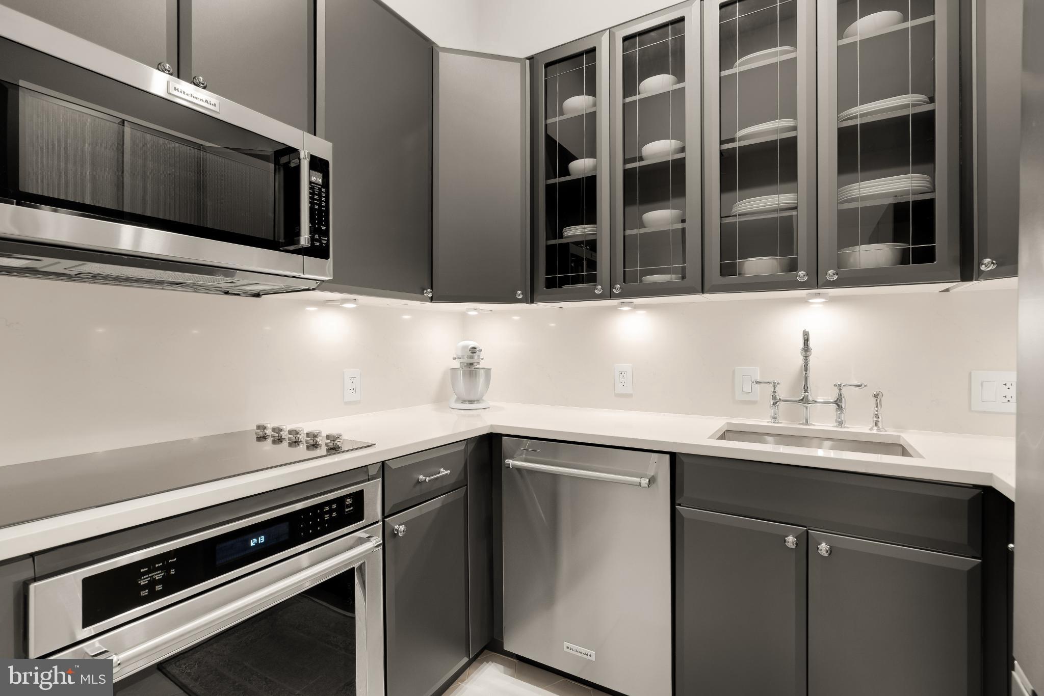 1704 19th Street Northwest, Unit 5 Washington, DC 20009 - Photo 14 of 25 a kitchen with stainless steel appliances a sink stove and microwave