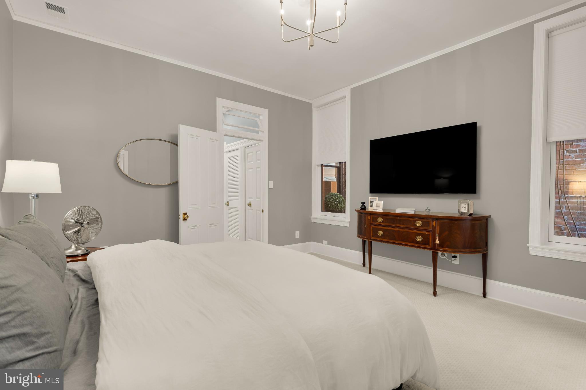 1704 19th Street Northwest, Unit 5 Washington, DC 20009 - Photo 21 of 25 a bedroom with a bed and a flat screen tv