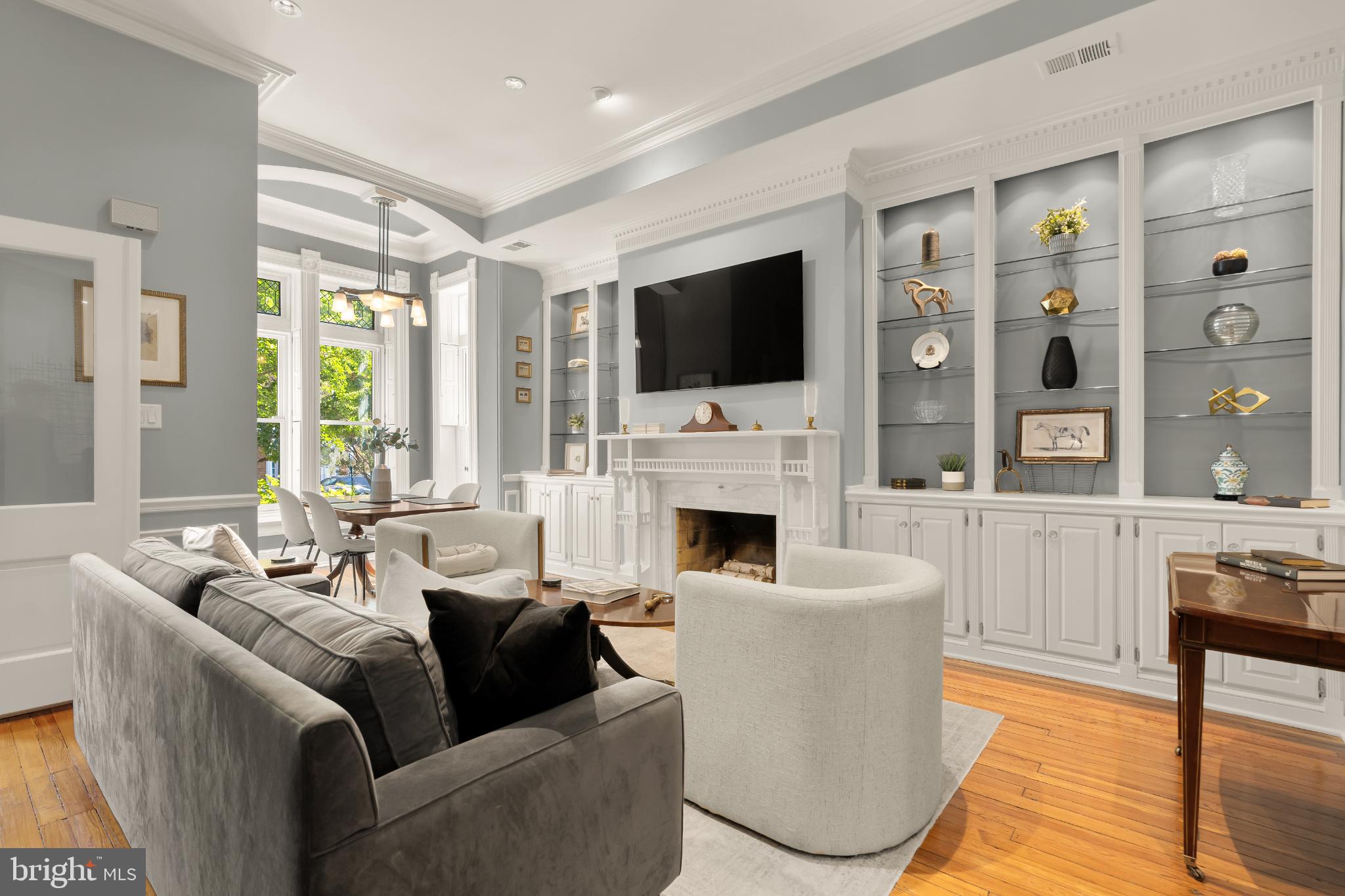 1704 19th Street Northwest, Unit 5 Washington, DC 20009 - Photo 7 of 25 a living room with furniture a fireplace and a flat screen tv